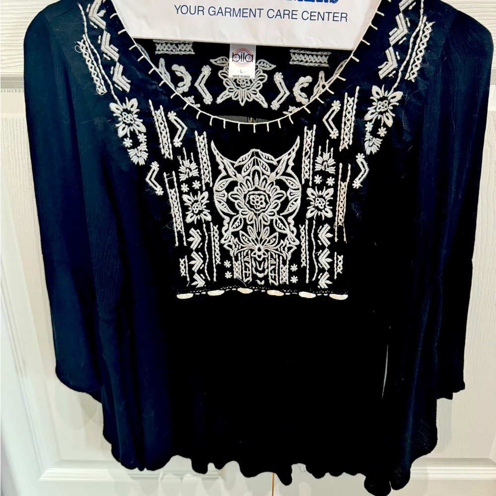 Flowy black gauze-like top with white embroidery and bell sleeves